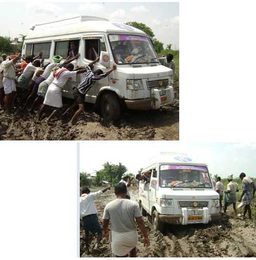 Relief vechiel being helped by the local to cross over a muddy road